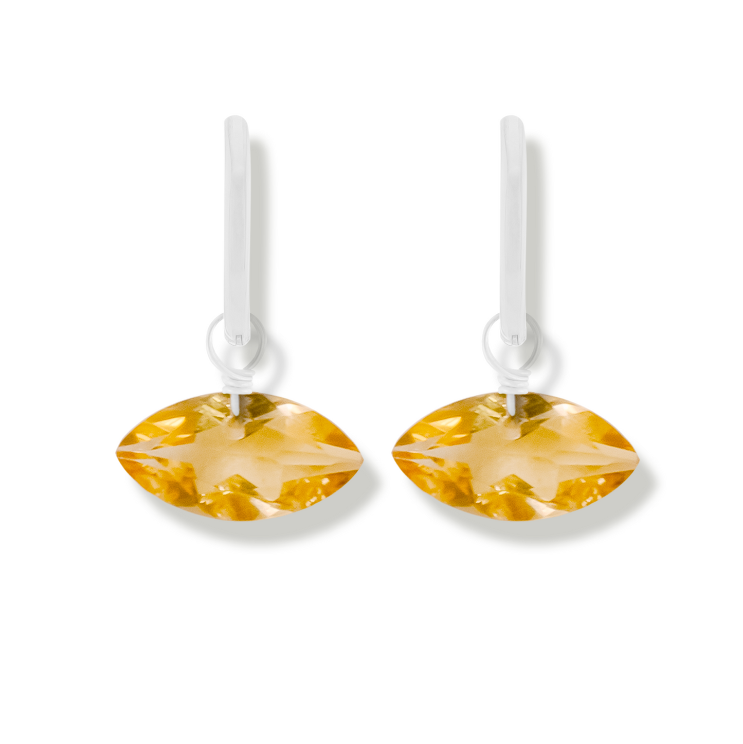 pair of silver earrings with citrine marquise cut gemstones on a white background.
