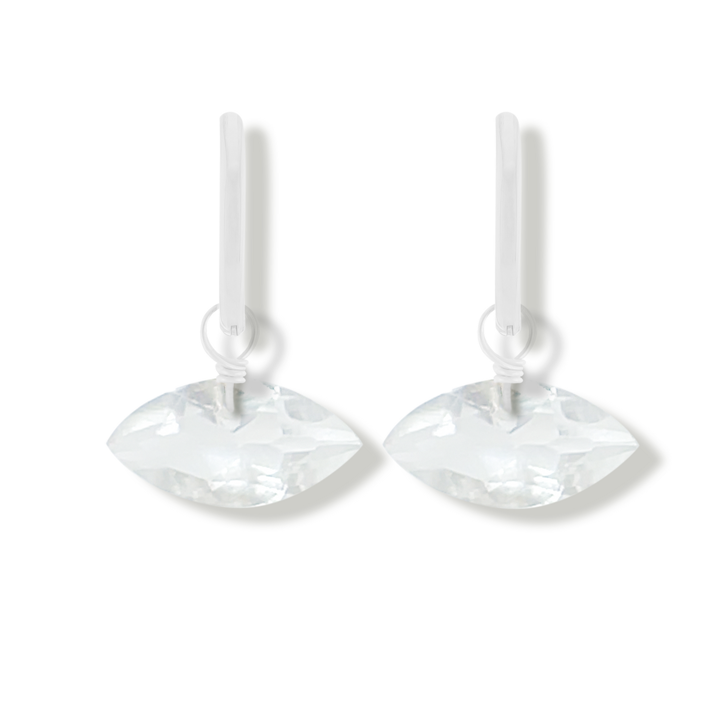 pair of silver earrings with rock crystal marquise cut gemstones on a white background.