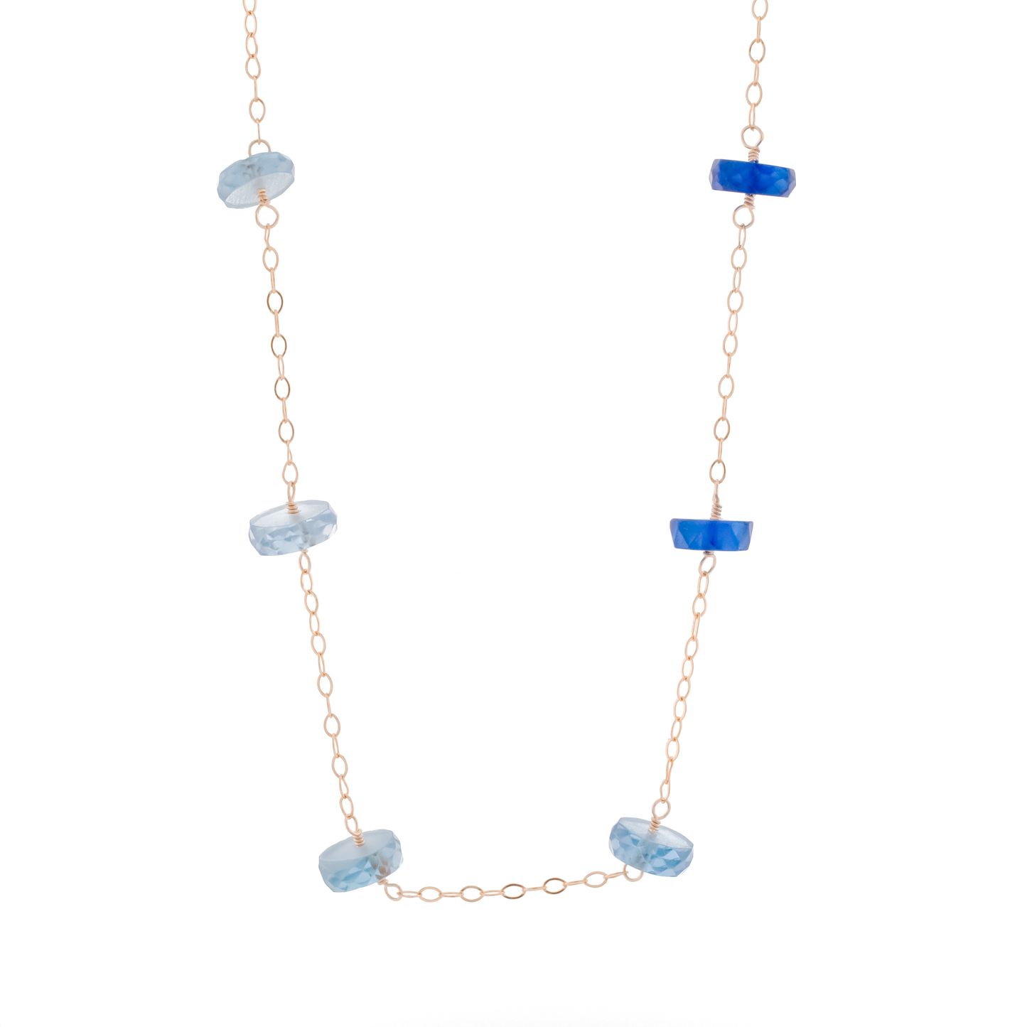 A gold-filled chain necklace with powder blue to rich royal blue sapphire rondelles arranged in an ombre gradient fashion.