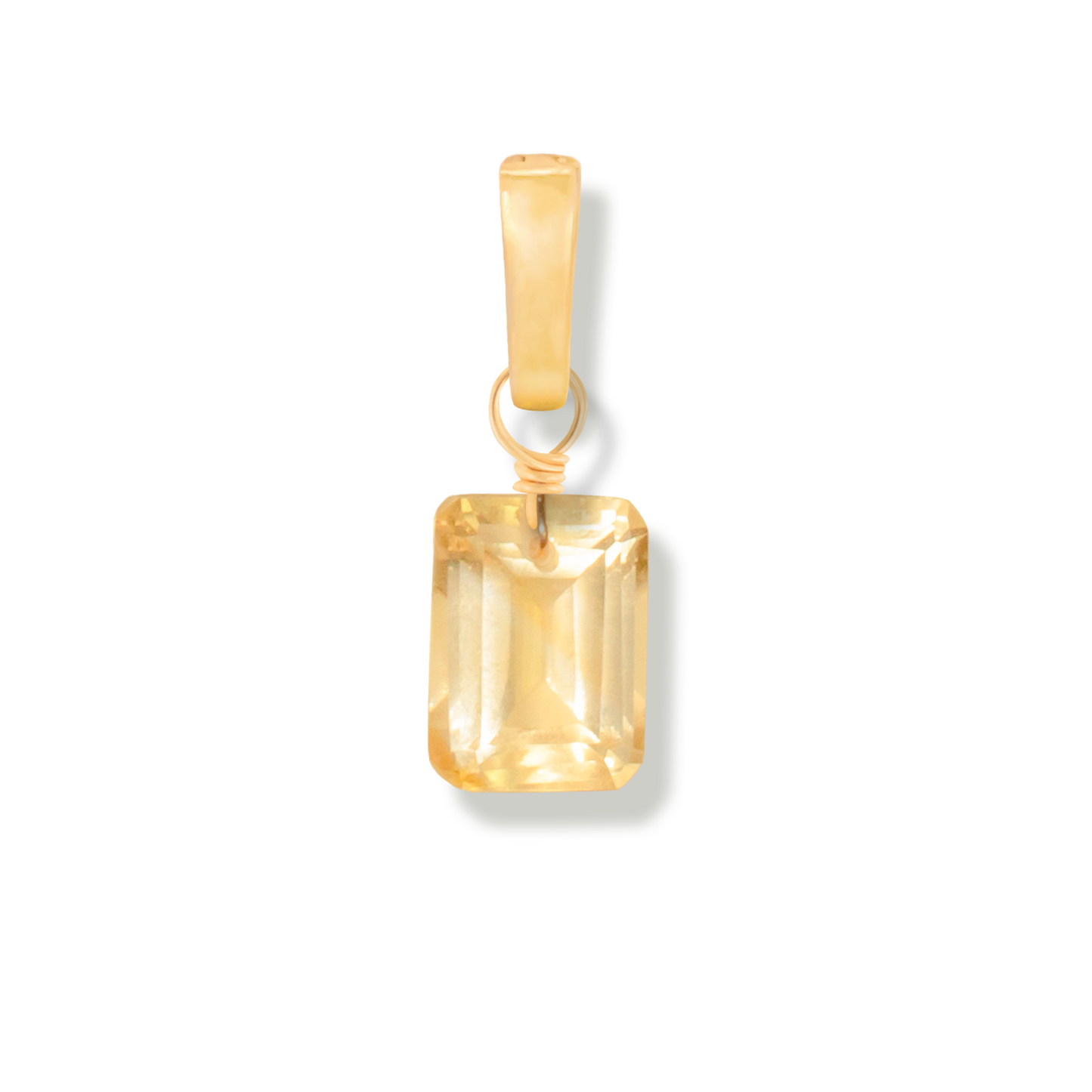 Gold pendant with a rectangular citrine stone on a white background