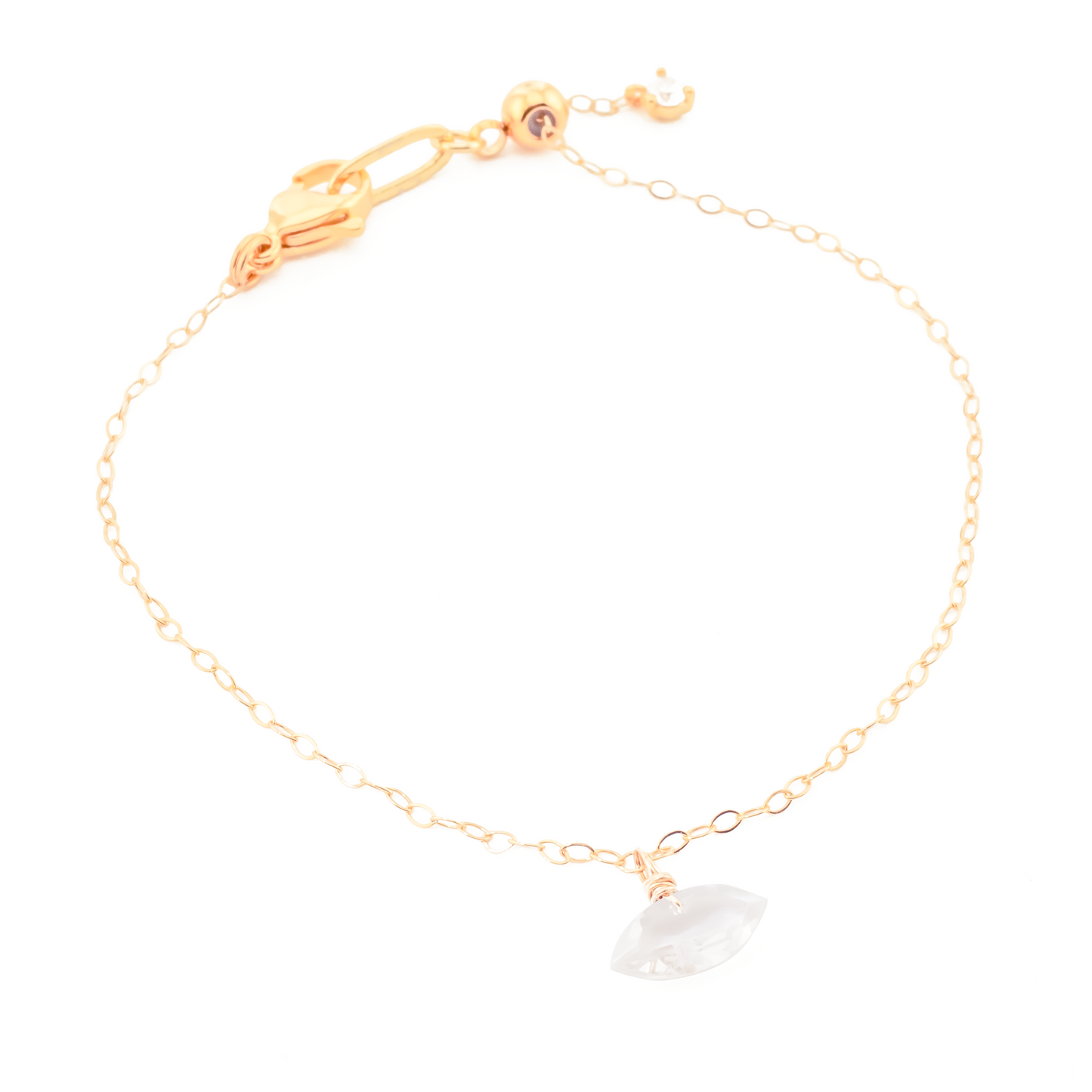 Gold bracelet with a rock crystal marquise cut gemstone on a white background
