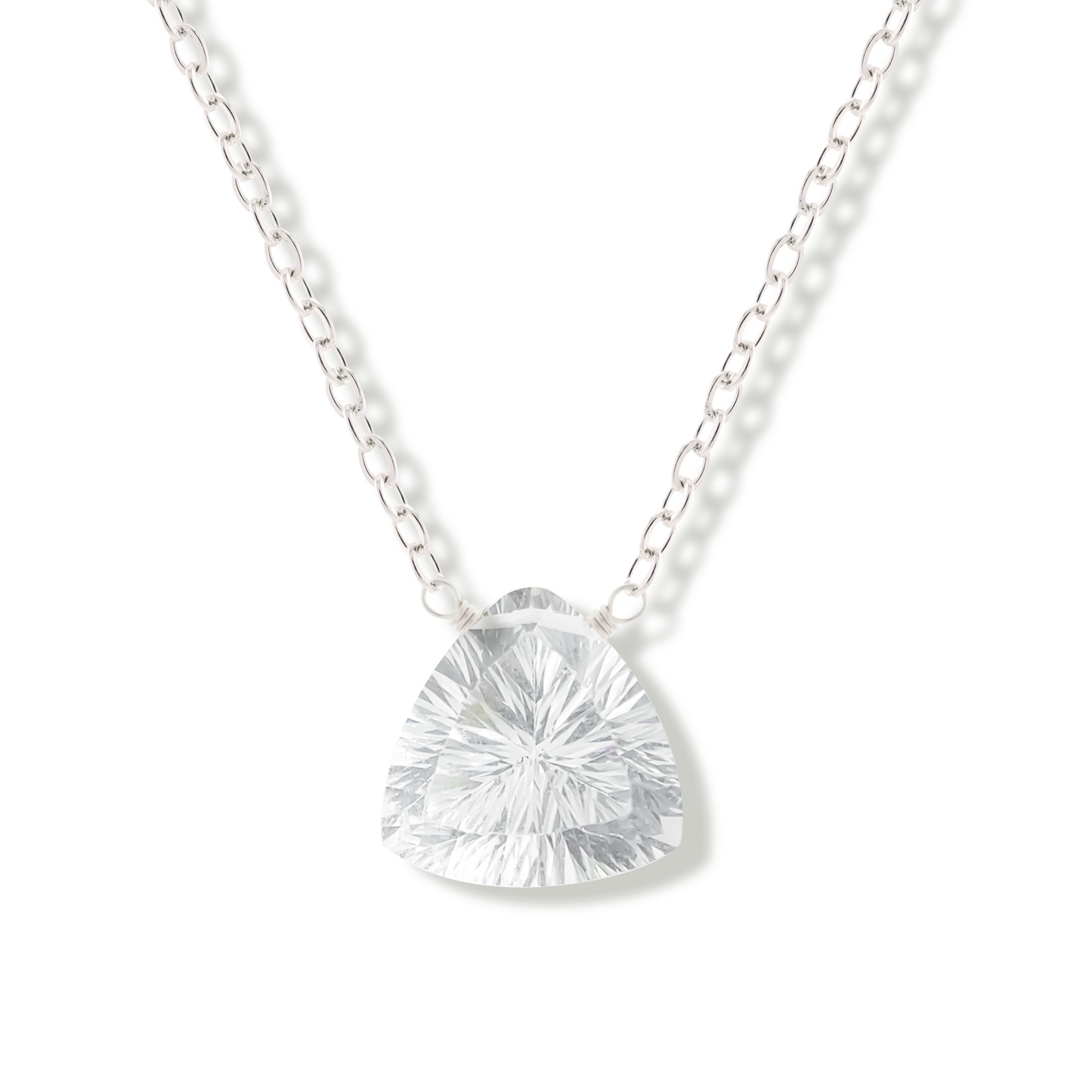 Silver necklace with a rock crystal gemstone pendant on a white background