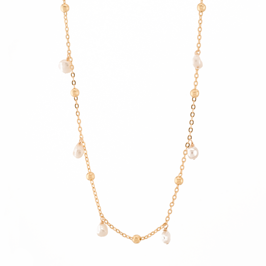 gold necklace with gold beads and baroque pearls on a white background.
