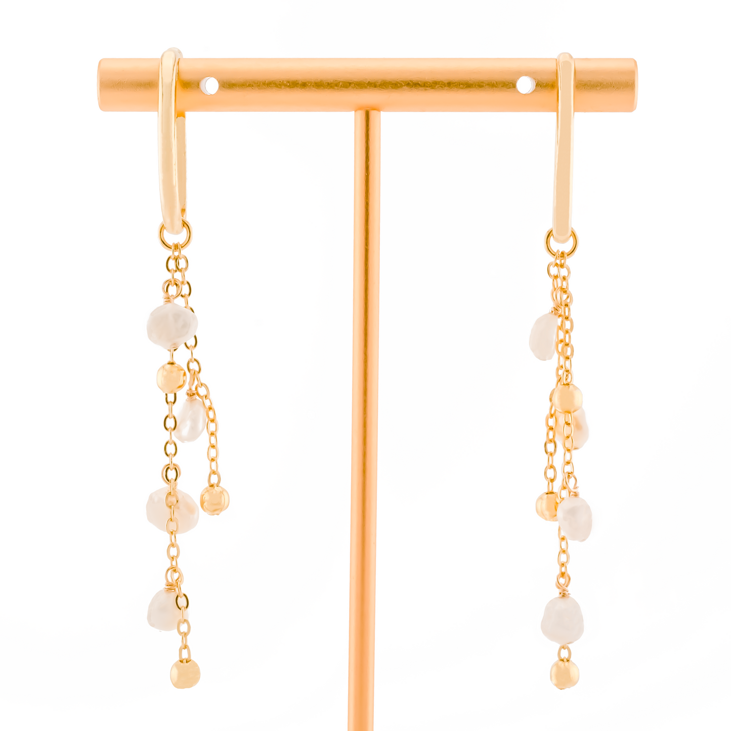 pair of gold ear cuffs with detachable charm of baroque pearls on gold chain on a white background.