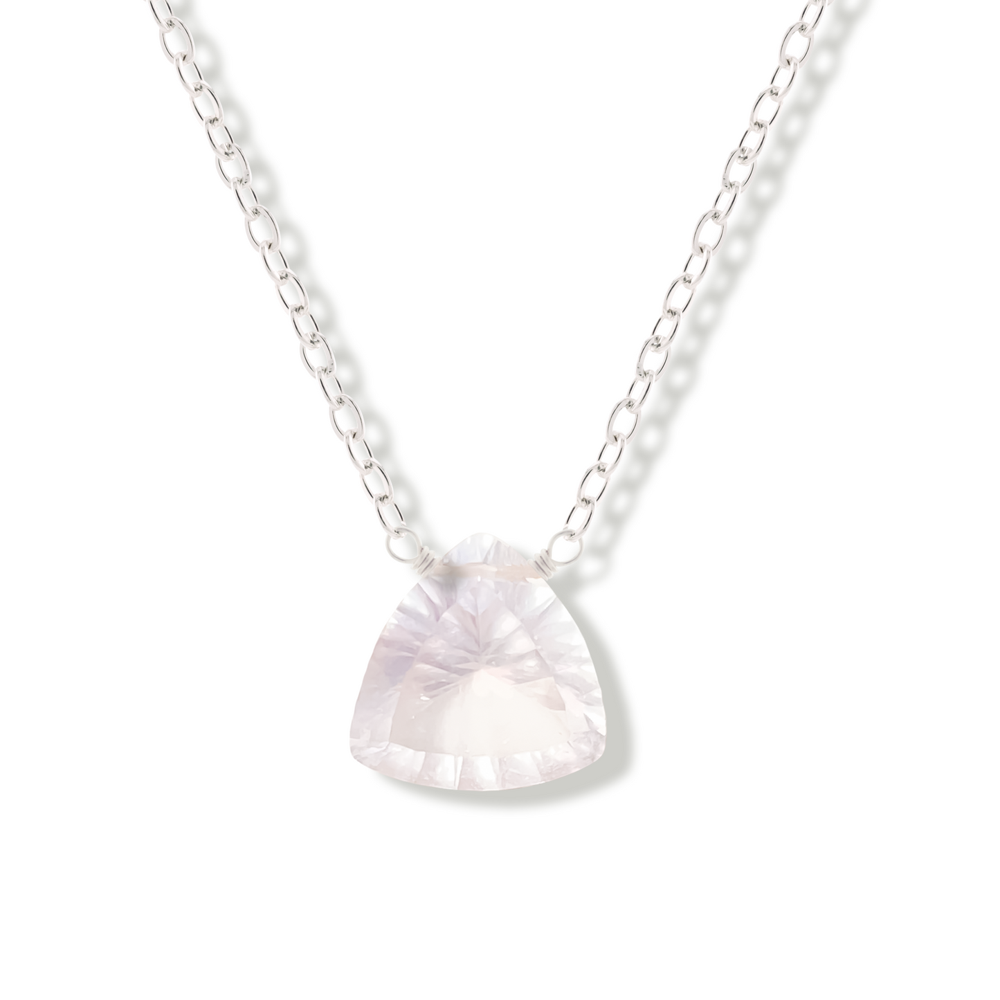 rose quartz trillion cut gemstone pendant on a sterling silver chain on a white background.