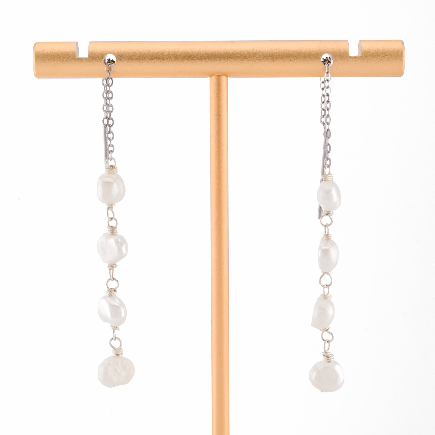 baroque pearls on silver threader earrings on a white background.