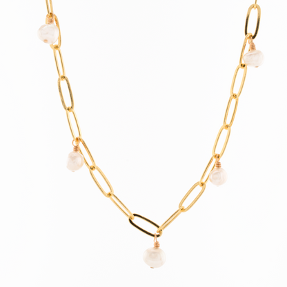 A gold filled paperclip chain necklace with stations adorned with baroque freshwater pearls.