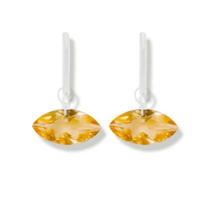 pair of silver earrings with citrine marquise cut gemstones on a white background.