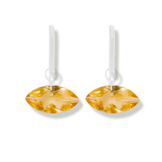 pair of silver earrings with citrine marquise cut gemstones on a white background.