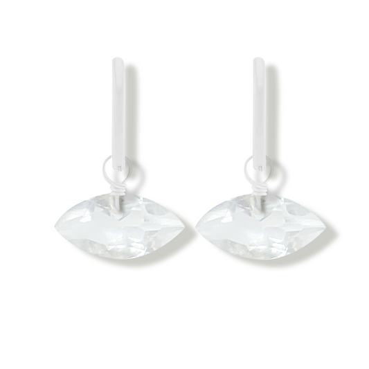 pair of silver earrings with rock crystal marquise cut gemstones on a white background.