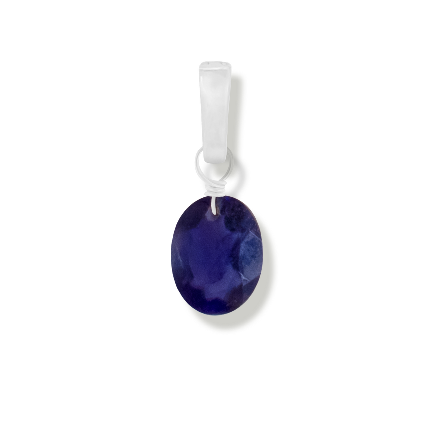 Iolite oval cut gemstone charm on a white background.