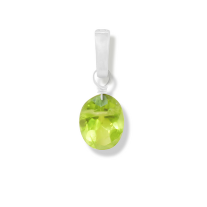 Peridot oval cut charm on a white background.