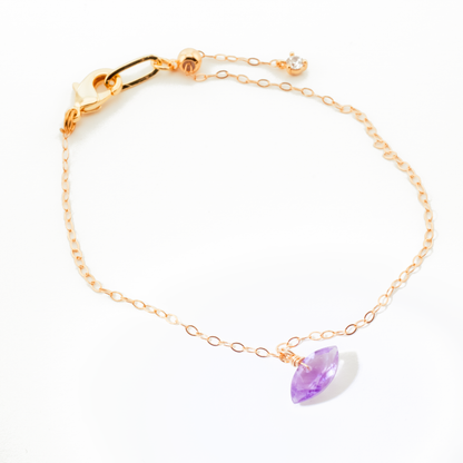Gold bracelet with a brazilian pink amethyst marquise cut gemstone on a white background
