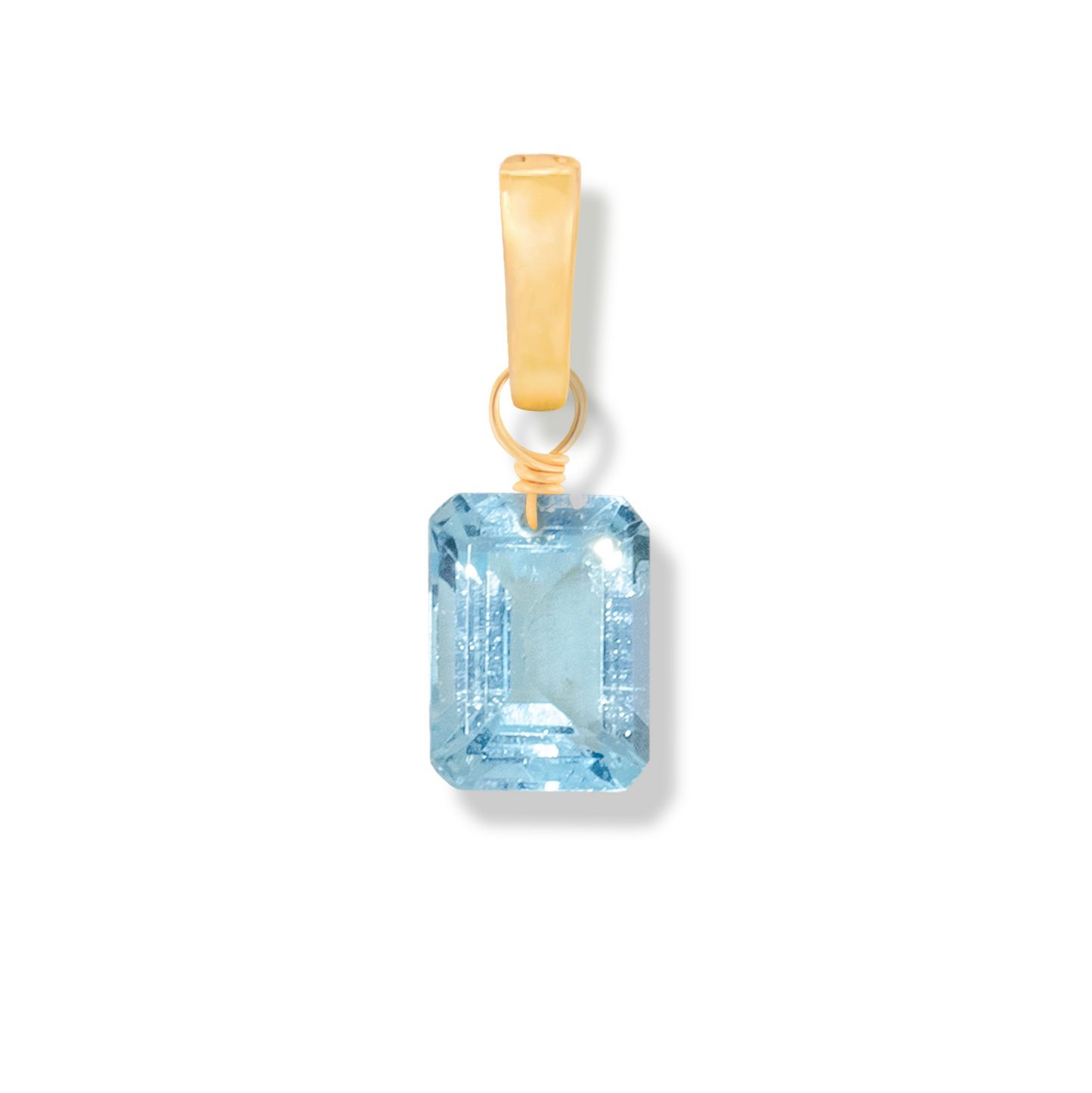 Gold pendant with a blue topaz rectangle cut gemstone on a white background