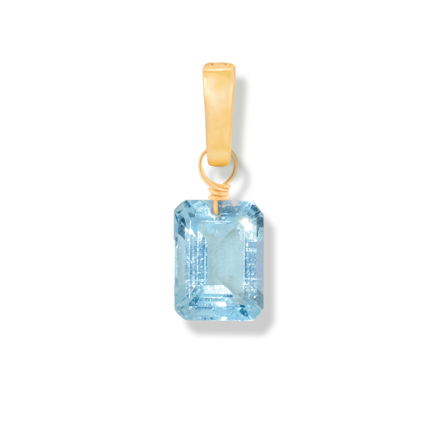 Gold pendant with a blue topaz rectangle cut gemstone on a white background