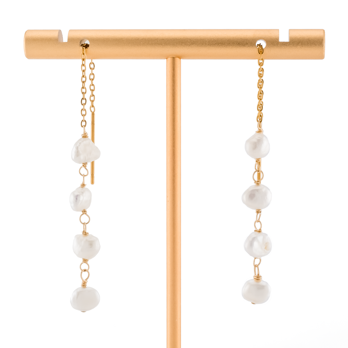 baroque pearls on gold threader earrings on a white background.