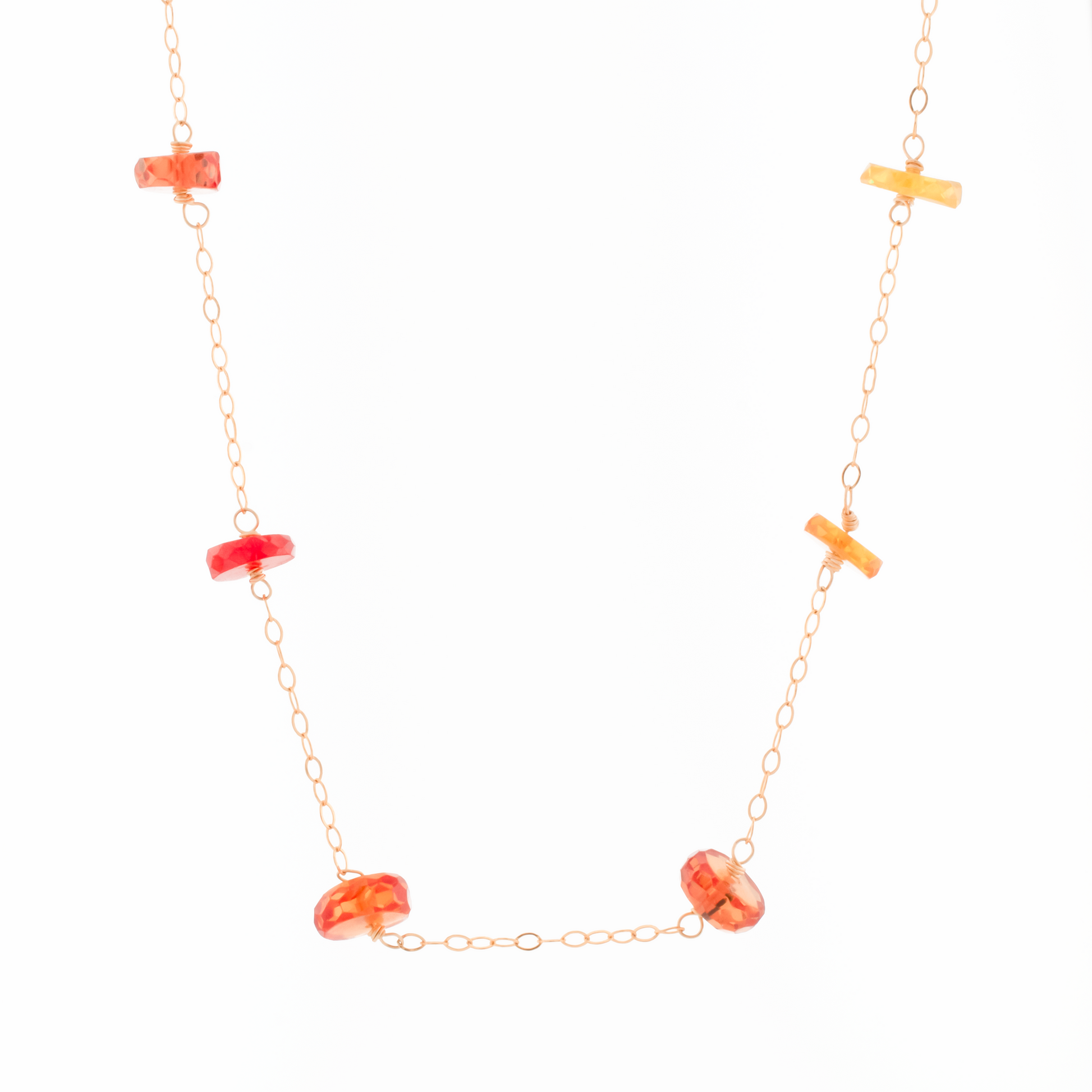 A gold-filled chain necklace with station of padparadscha sapphires in ombre gradient from sunny orange to lemon shades.