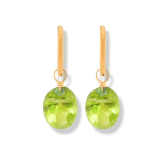 pair of 14k gold-filled hoop earrings with peridot oval cut gemstones on a white background.