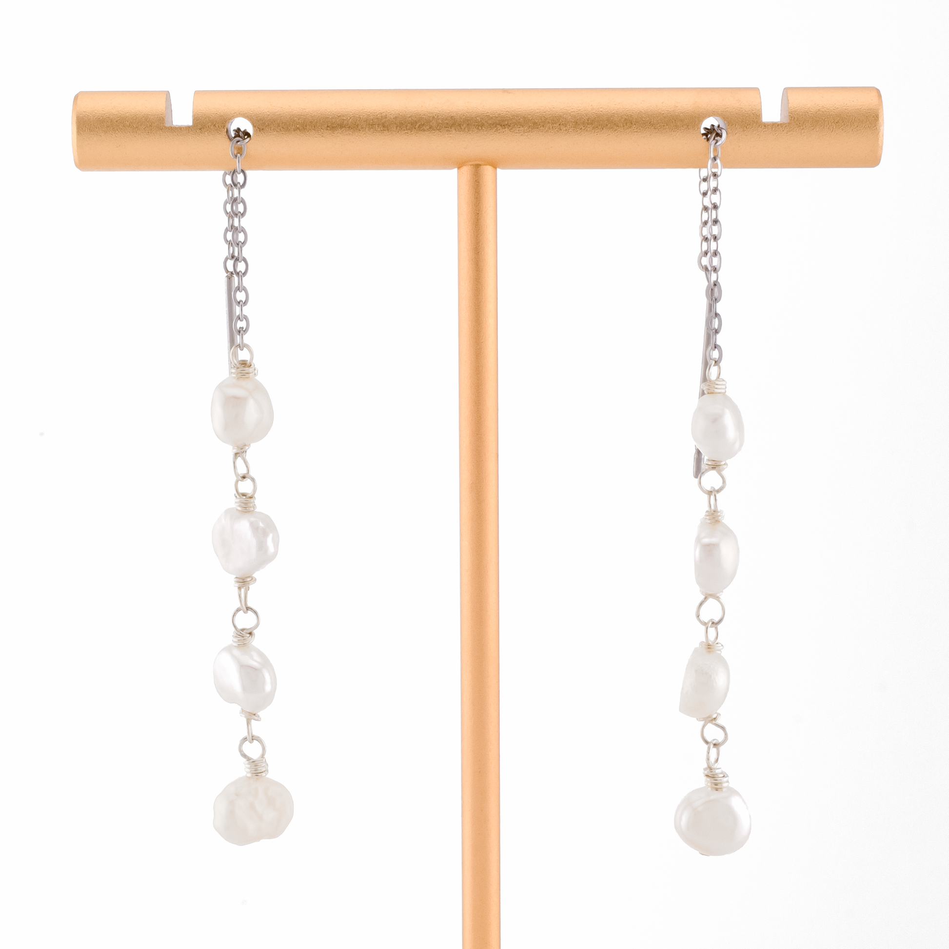baroque pearls on silver threader earrings on a white background.